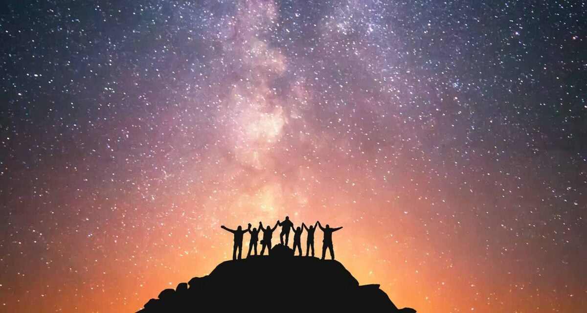 Photo of a starry sky with silhouettes of people