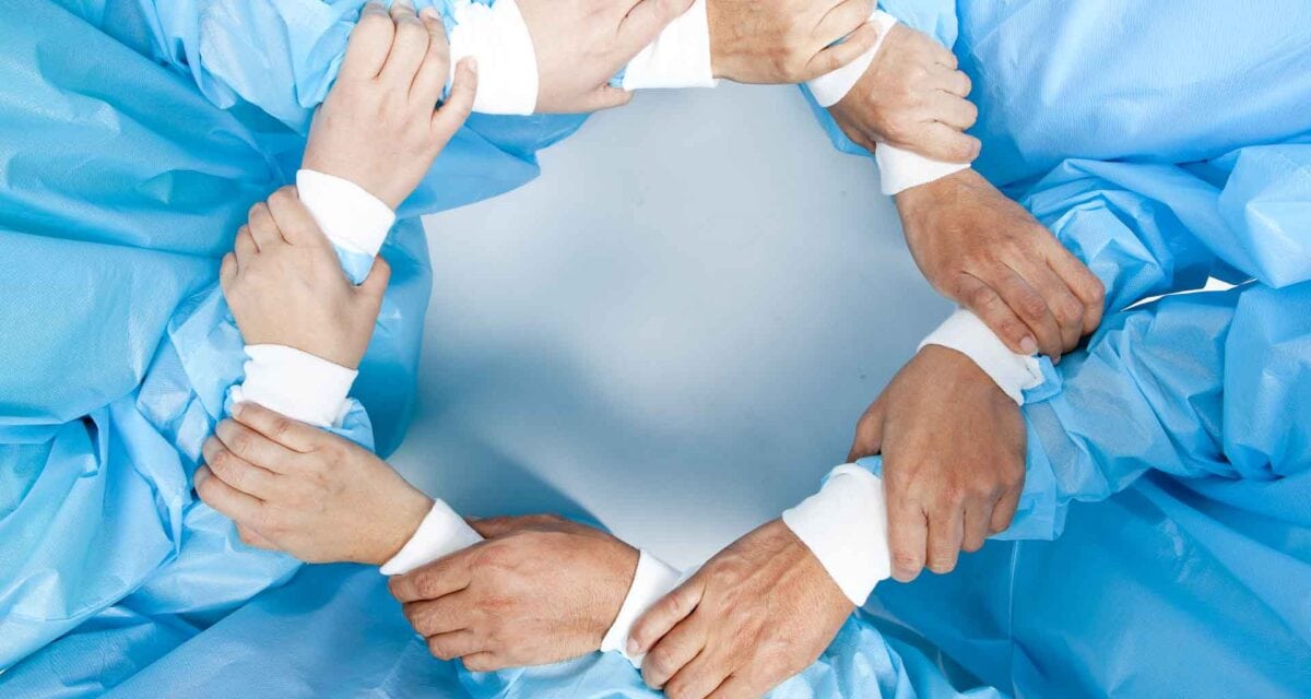 Photo of hands of surgeons forming a circle