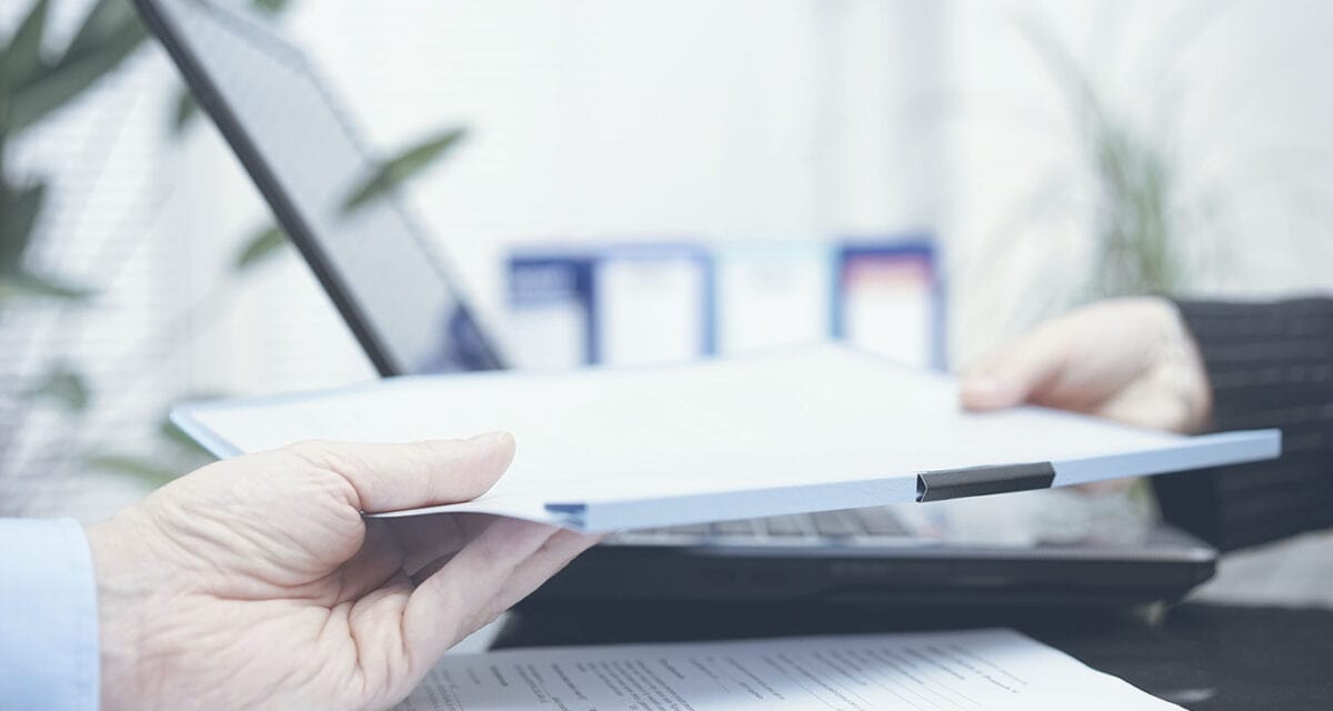 Person handing papers