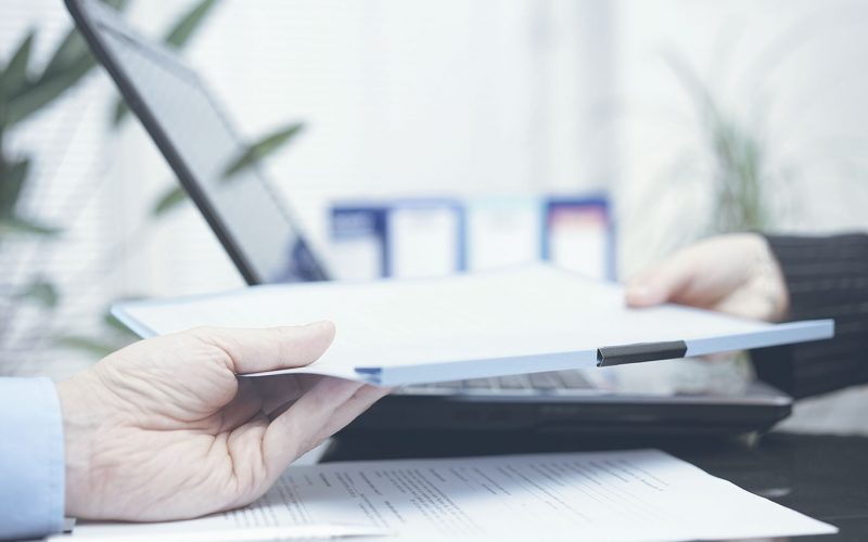 Person handing papers