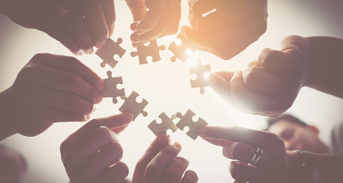 People holding puzzle pieces