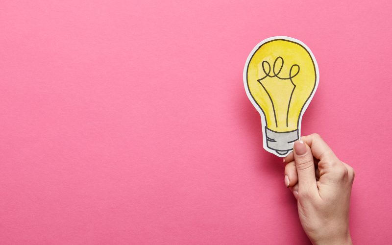 hand holding a cartoon lightbulb