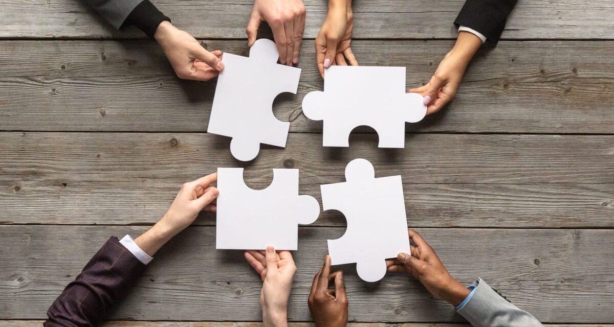 Hands holding puzzle pieces