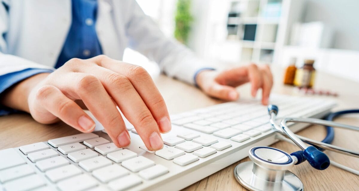 Female doctor typing on computer