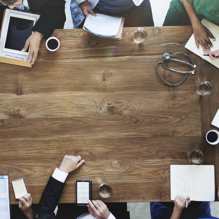 Group of professionals and medical staff at the discussion table